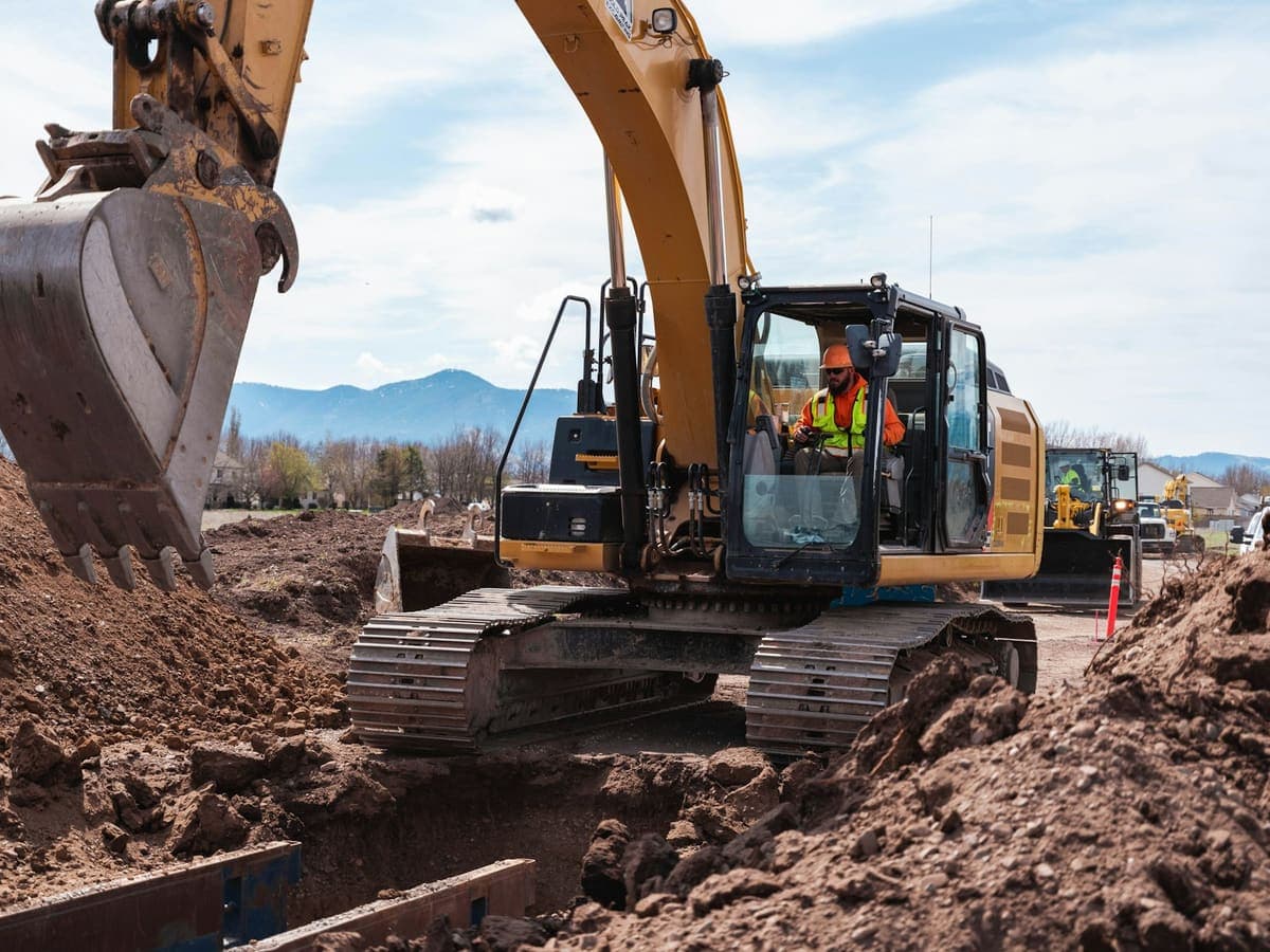 Excavator digging a trench on a job site